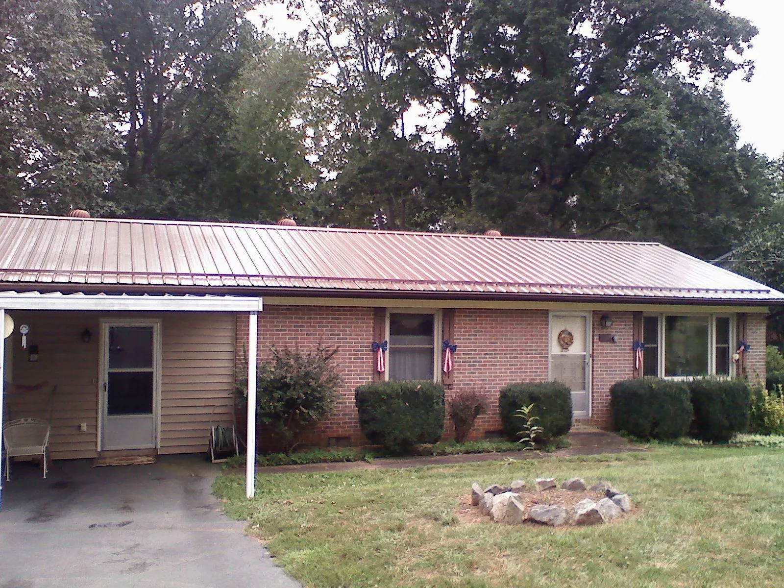 Bronze metal roof and carport on a brick ranch home — Roof Repair work by our crew in Ocean Grove