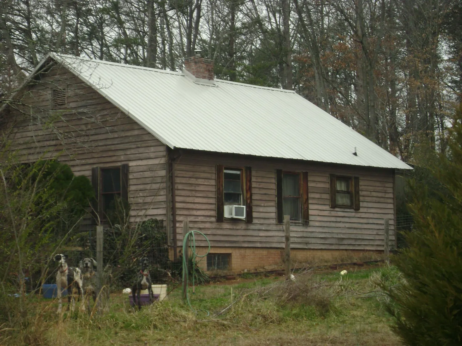 White metal roof on an old wood sided farmhouse, from a Metal Roof Installation job in Ocean Grove